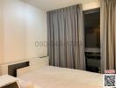 Spacious bedroom with large bed and grey curtains