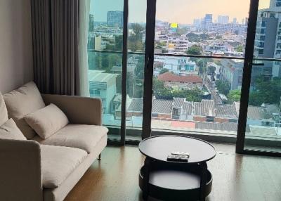 Modern living room with large windows and city view