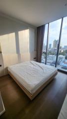 Modern bedroom with a large window and city view