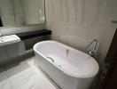 Modern bathroom interior with freestanding bathtub and reflective tiles