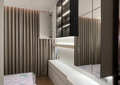 Modern bedroom interior with unmade bed and built-in wardrobe