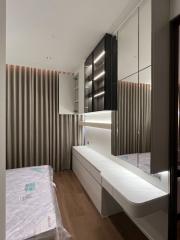 Modern bedroom interior with unmade bed and built-in wardrobe