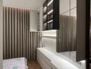 Modern bedroom interior with unmade bed and built-in wardrobe