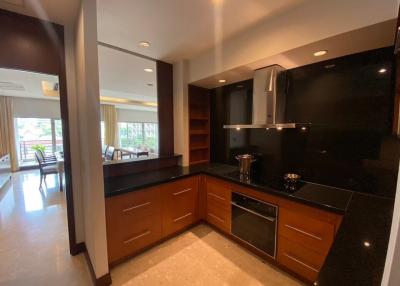 Modern kitchen with wooden cabinets and black countertops