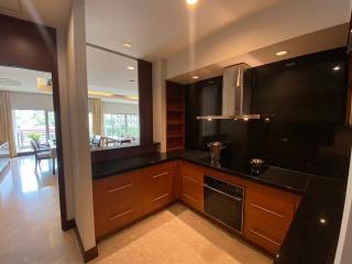 Modern kitchen with wooden cabinets and black countertops