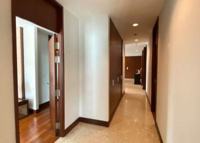 Spacious hallway interior with polished floor and wooden doors