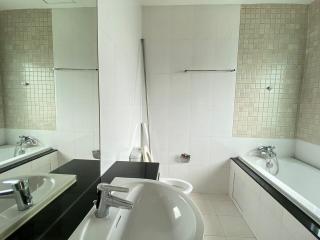 Spacious Modern Bathroom with Double Vanity and Tiled Walls