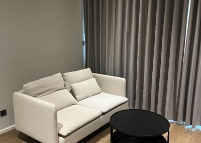 Modern living room interior with white sofa and black round coffee table