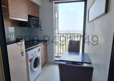 Modern kitchen with dining area and city view through large windows