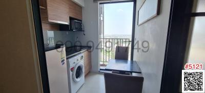 Modern kitchen with dining area and city view through large windows