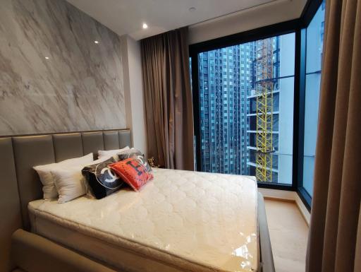 Modern bedroom with large windows and city view