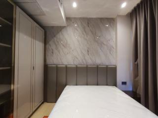 Modern bedroom with marble walls and built-in wardrobe