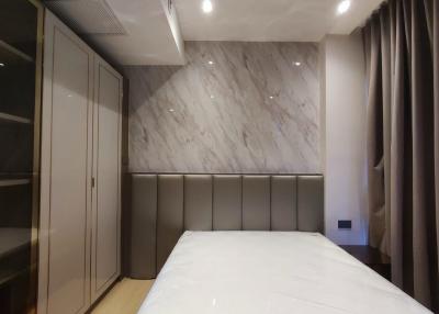 Modern bedroom with marble walls and built-in wardrobe