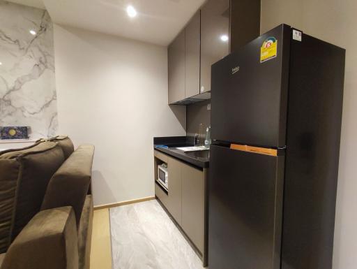 Modern kitchen with marble wall and integrated appliances