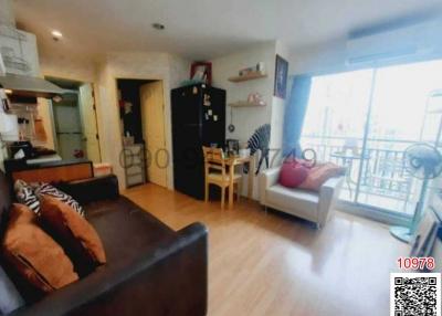 Spacious and well-lit living room with modern furniture and balcony access