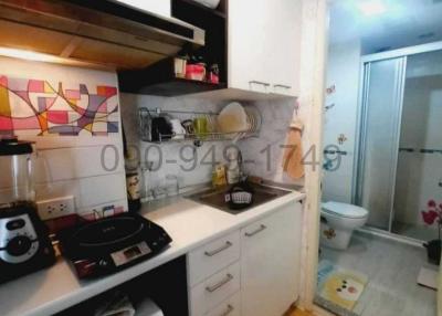 Compact fully-equipped kitchen with modern appliances and white cabinets