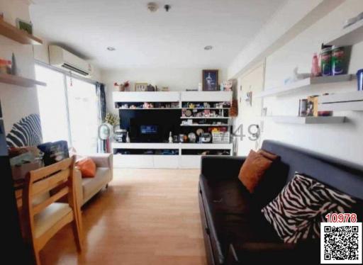 Spacious living room with modern furnishings and hardwood flooring