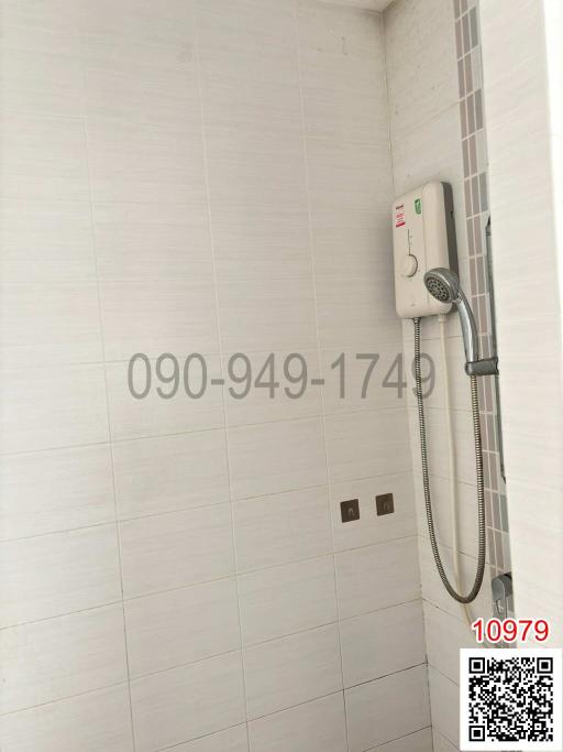 Modern white tiled bathroom with shower fixture