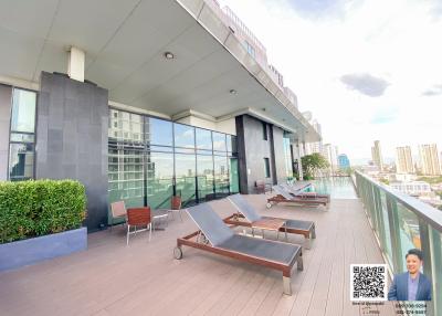 Spacious rooftop terrace with lounging chairs and panoramic city view