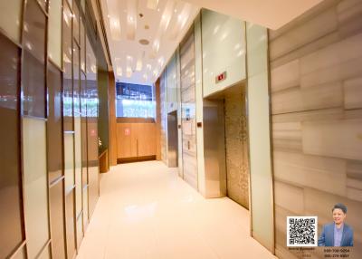 Modern building lobby with bright lighting and wood paneling