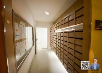 Mailroom with multiple mailboxes in an apartment building corridor