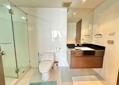 Modern bathroom interior with glass shower and wooden vanity