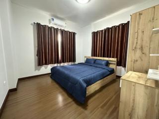 Cozy bedroom with double bed and wooden furniture