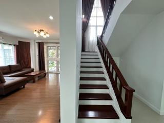 Spacious living area with staircase and natural lighting