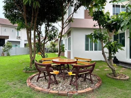 Spacious outdoor garden with a dining area and lush greenery