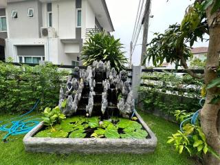 Cozy residential garden with a decorative water fountain