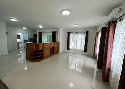 Spacious and bright living room with shiny tiled floor and large windows