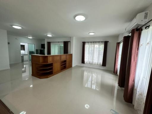 Spacious and bright living room with shiny tiled floor and large windows