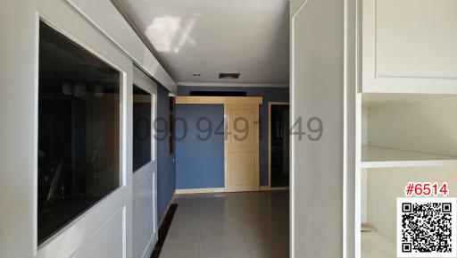 Spacious hallway with natural light and built-in shelves