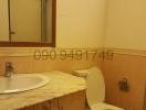 Spacious bathroom interior with marble countertop sink and tiled walls