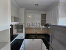 Modern kitchen with stainless steel appliances and white cabinetry