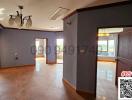 Spacious interior view of a vacant building with tiled flooring and multiple doorways