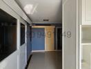 Spacious interior view of a home featuring shelves, corridor, and entrance to adjacent rooms