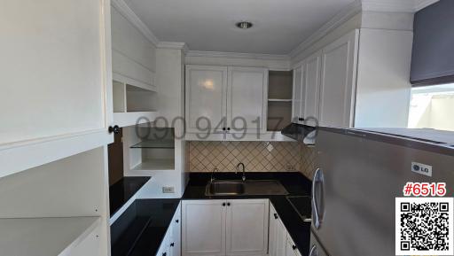 Modern kitchen with white cabinetry and stainless steel appliances