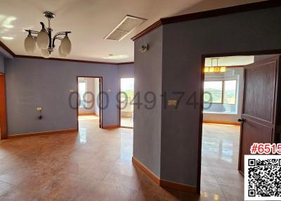 Spacious and bright living room with tiled flooring and multiple doorways