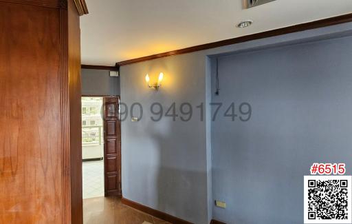 Hallway interior with wooden floors and wall sconces