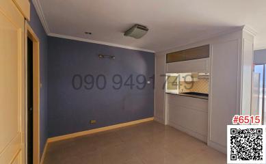 Modern kitchen with integrated appliances and blue feature wall