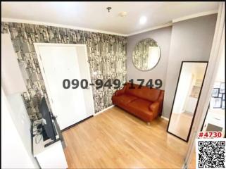 Contemporary living room with patterned wallpaper and hardwood floors