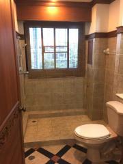 Modern tiled bathroom with a large window