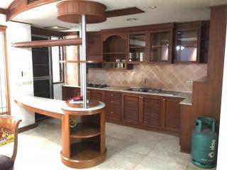 Spacious kitchen with wooden cabinets and modern appliances