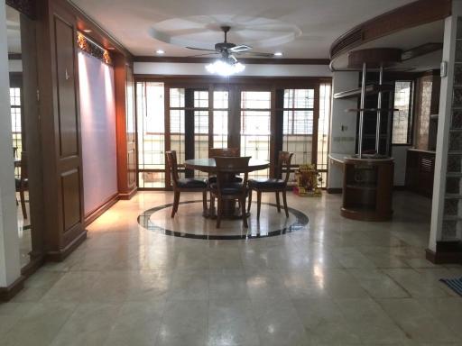 Spacious living room with dining area and tiled flooring