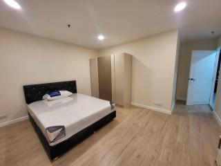 Spacious bedroom with large bed and built-in wardrobe