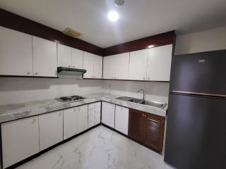 Modern kitchen with white cabinets and stainless steel appliances