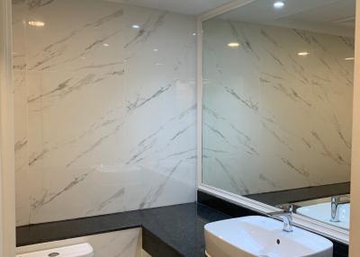 Modern bathroom with marble walls and a vessel sink