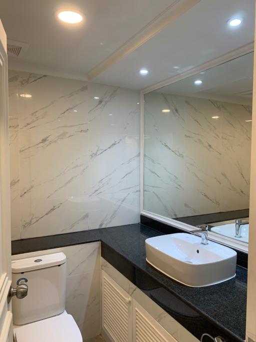 Modern bathroom with marble walls and a vessel sink