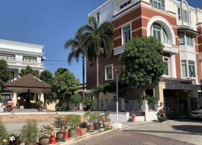 Elegant residential building with tropical landscaping and ample parking space